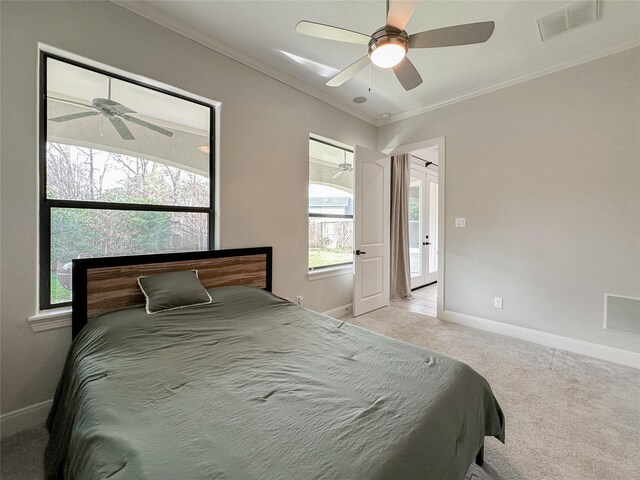 bedroom featuring ceiling fan, light colored carpet, and ornamental molding