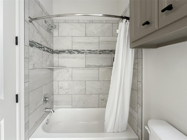 bathroom with shower / tub combo and toilet