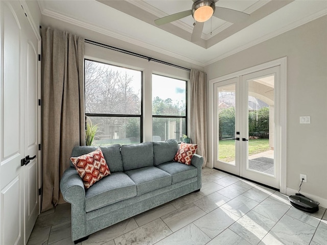 interior space with ceiling fan, crown molding, french doors, and a raised ceiling