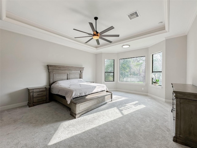 bedroom featuring carpet flooring, visible vents, baseboards, ornamental molding, and a raised ceiling