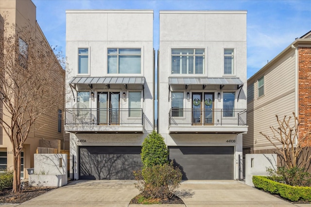 view of front facade with a balcony and a garage