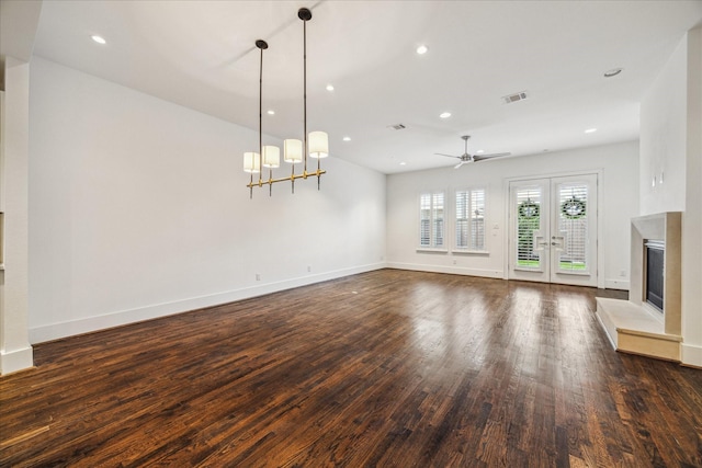 unfurnished living room featuring dark hardwood / wood-style floors, french doors, and ceiling fan