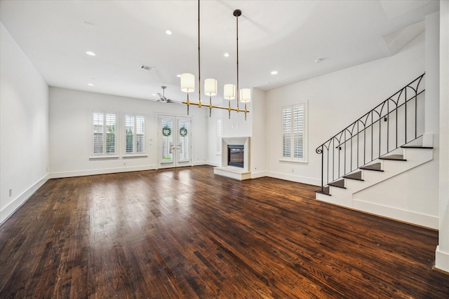 unfurnished living room featuring dark hardwood / wood-style floors and french doors