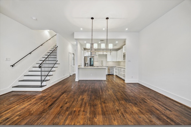 unfurnished living room with dark hardwood / wood-style flooring