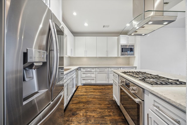 kitchen featuring white cabinetry, appliances with stainless steel finishes, dark hardwood / wood-style flooring, island exhaust hood, and light stone countertops