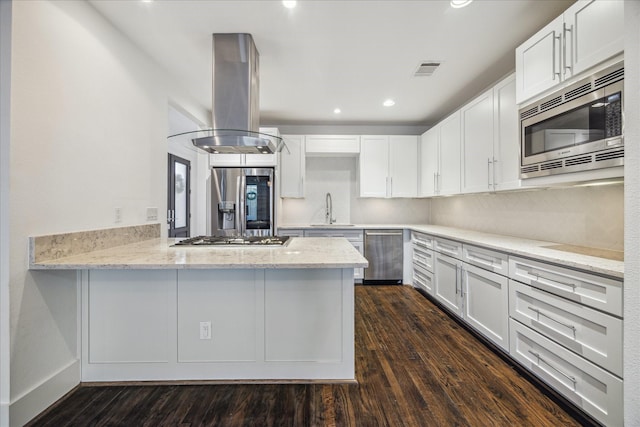 kitchen with white cabinets, stainless steel appliances, sink, and island range hood