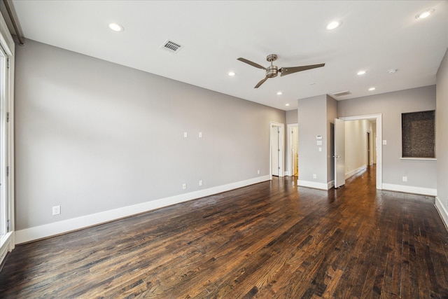 unfurnished living room featuring dark wood-type flooring and ceiling fan