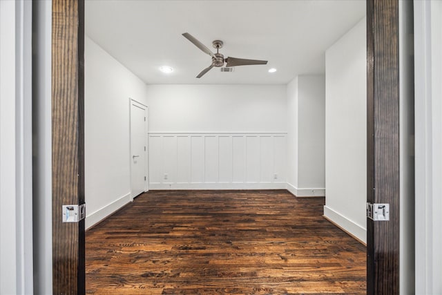 empty room featuring dark wood-type flooring and ceiling fan