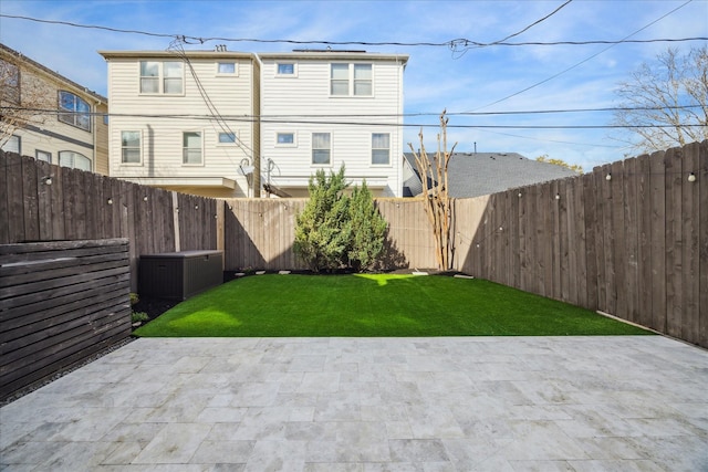 rear view of property featuring a yard and a patio area