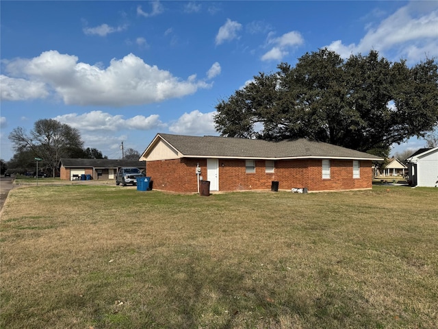 rear view of house featuring a yard