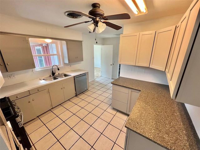 kitchen with sink, light tile patterned floors, ceiling fan, appliances with stainless steel finishes, and white cabinets