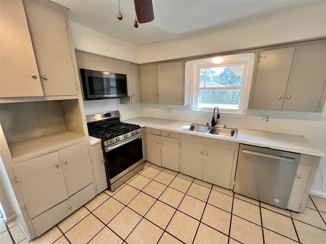 kitchen featuring stainless steel appliances, sink, light tile patterned floors, and ceiling fan