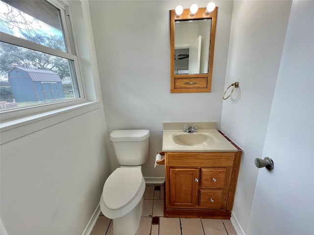 bathroom with vanity, toilet, and tile patterned flooring