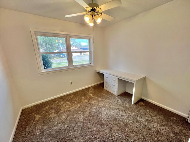 unfurnished office with dark carpet and ceiling fan