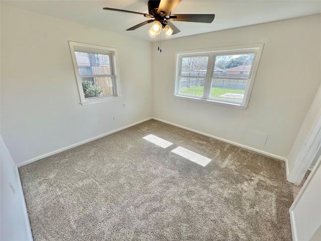 carpeted spare room with ceiling fan