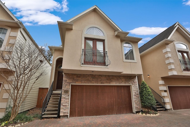 view of front of home with a garage and a balcony