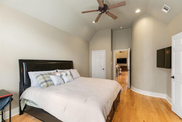 bedroom featuring vaulted ceiling, ceiling fan, and light hardwood / wood-style flooring