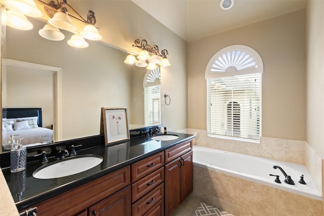 bathroom with vanity and a relaxing tiled tub