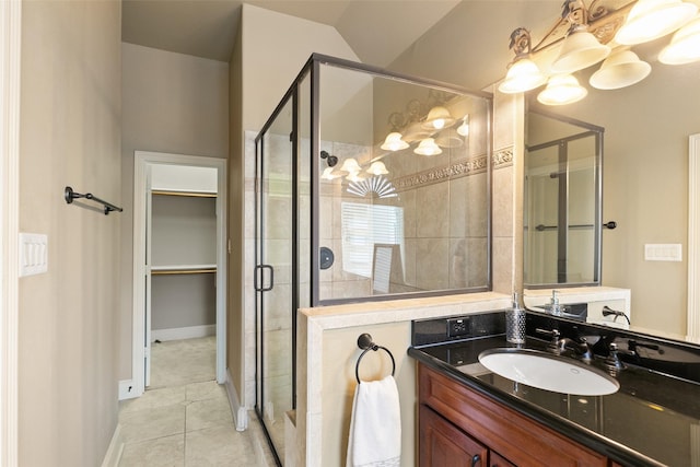 bathroom with vanity, a shower with door, and tile patterned flooring