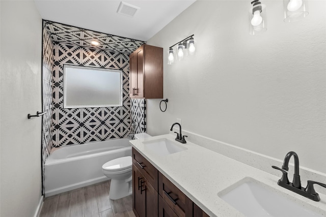 full bathroom with vanity, toilet, shower / washtub combination, and hardwood / wood-style floors