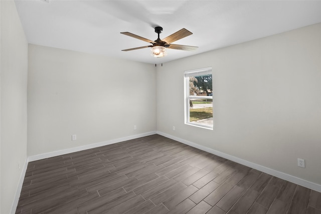 unfurnished room with ceiling fan and dark hardwood / wood-style flooring