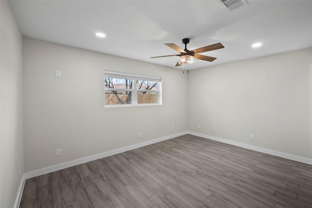 spare room with hardwood / wood-style flooring and ceiling fan