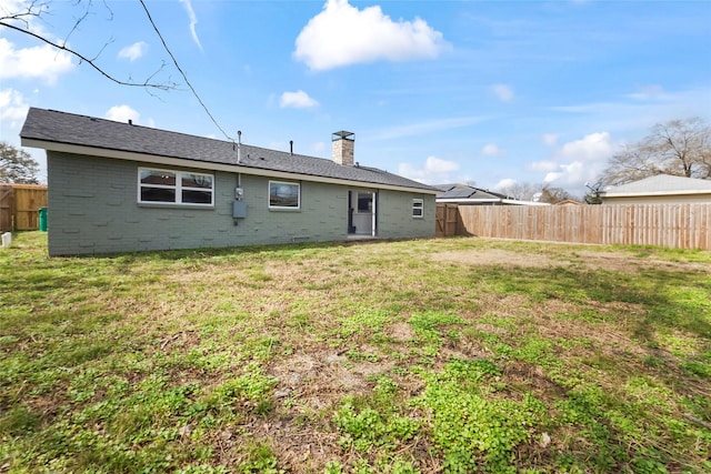 back of property featuring a lawn