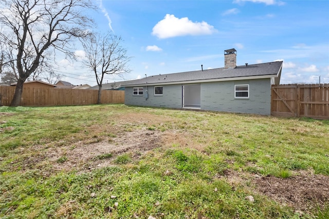 back of house featuring a yard