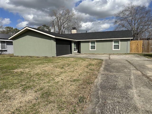 exterior space with a garage and a lawn