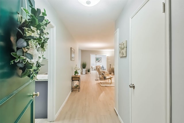 hall with light hardwood / wood-style flooring