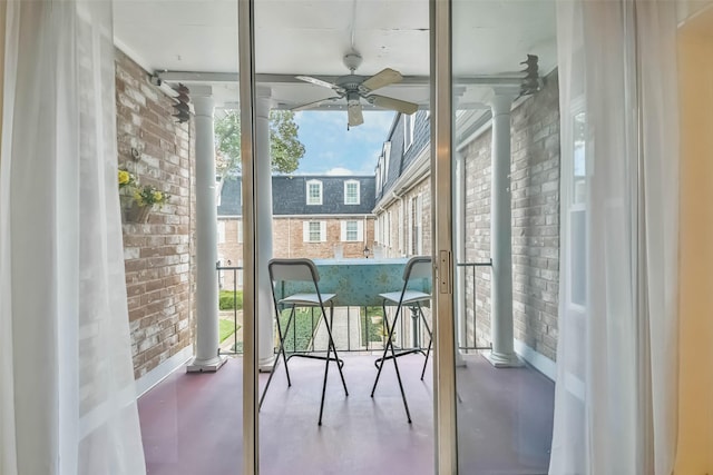 sunroom featuring decorative columns and ceiling fan