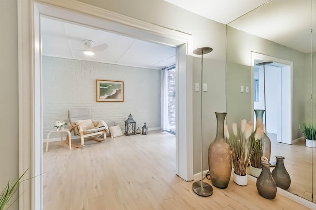 hallway with wood-type flooring and brick wall