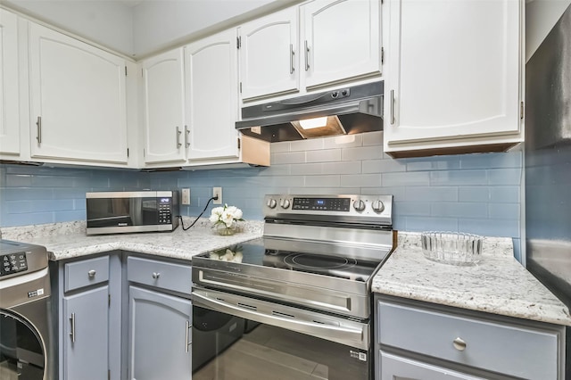 kitchen with gray cabinets, appliances with stainless steel finishes, washer / dryer, white cabinets, and decorative backsplash