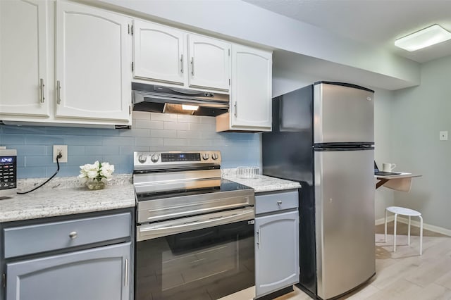 kitchen featuring decorative backsplash, light hardwood / wood-style flooring, white cabinets, and appliances with stainless steel finishes