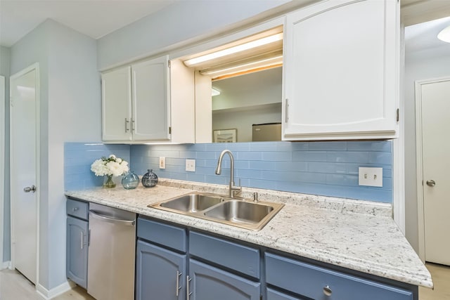 kitchen featuring white cabinetry, blue cabinets, dishwasher, and sink