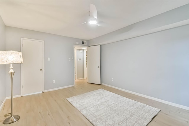 unfurnished bedroom with ceiling fan and light wood-type flooring