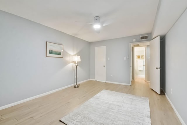 spare room with ceiling fan and light hardwood / wood-style floors