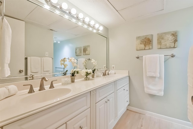 bathroom featuring hardwood / wood-style flooring and vanity