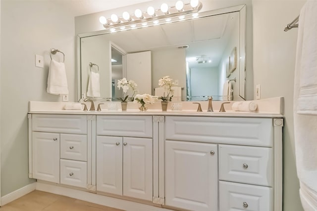 bathroom with tile patterned flooring and vanity