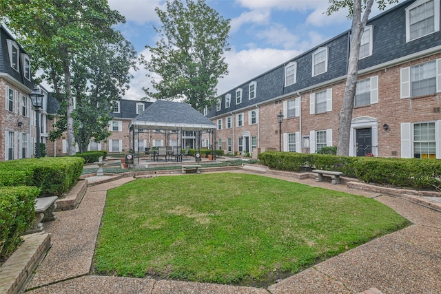 view of community with a gazebo and a lawn