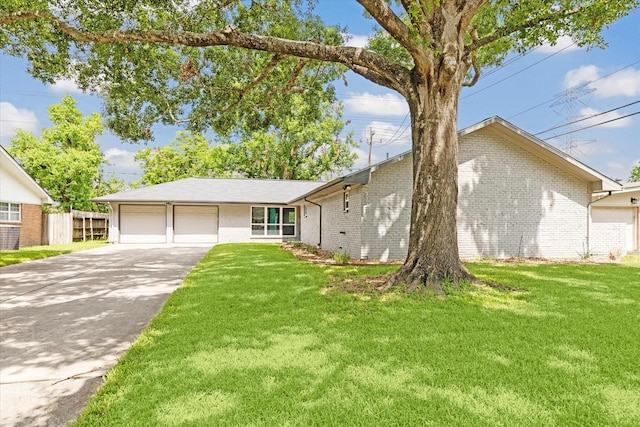 ranch-style house featuring a garage and a front yard