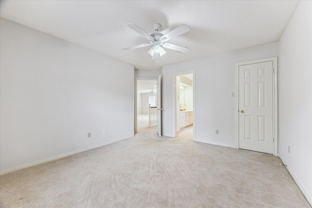 empty room featuring light colored carpet and ceiling fan