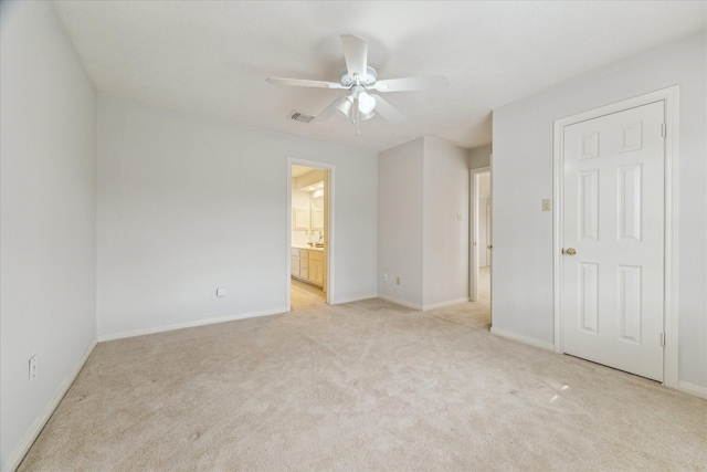 carpeted spare room with ceiling fan