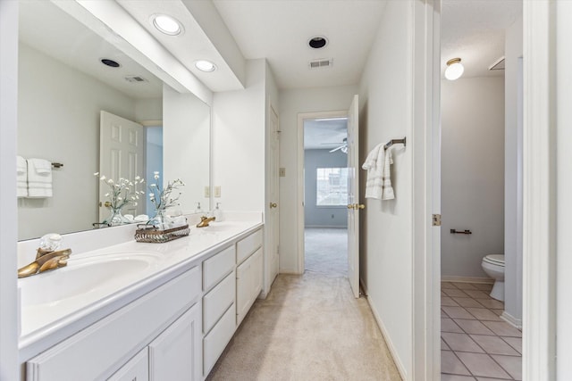 bathroom with vanity, toilet, and tile patterned flooring