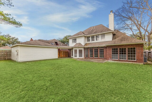 back of house featuring a yard