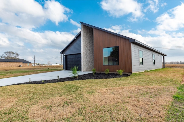 view of home's exterior featuring a garage and a lawn