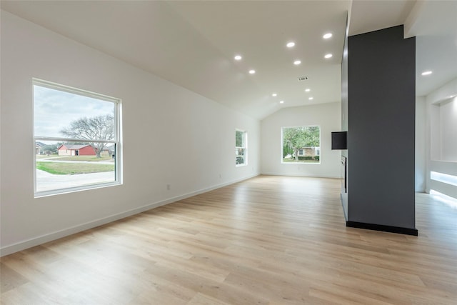 unfurnished living room with vaulted ceiling and light hardwood / wood-style floors