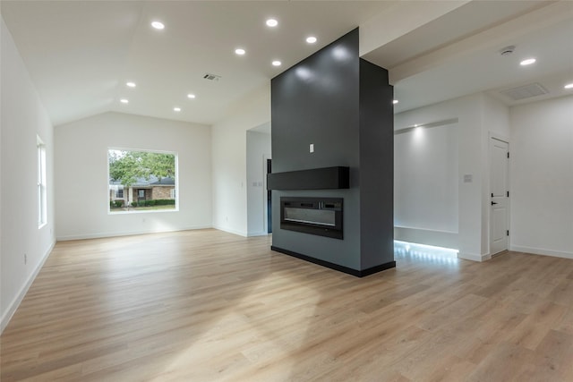 unfurnished living room with vaulted ceiling and light hardwood / wood-style flooring