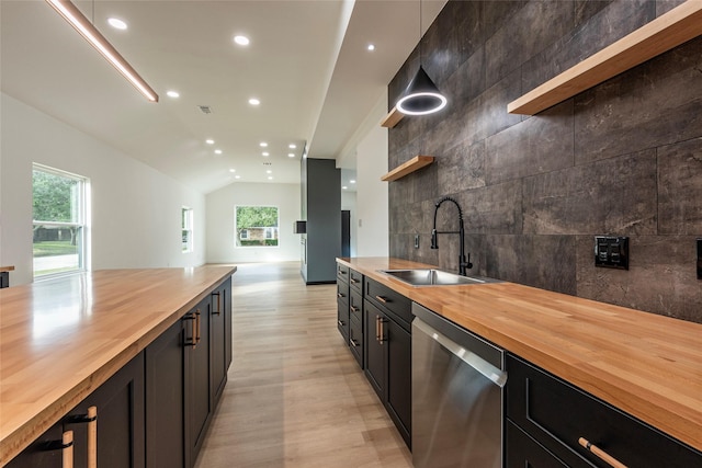 kitchen featuring dishwasher, plenty of natural light, sink, and wooden counters