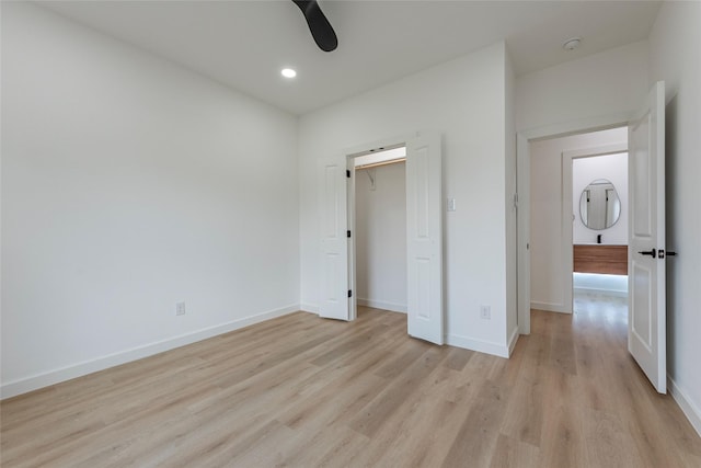 unfurnished bedroom featuring ceiling fan and light wood-type flooring